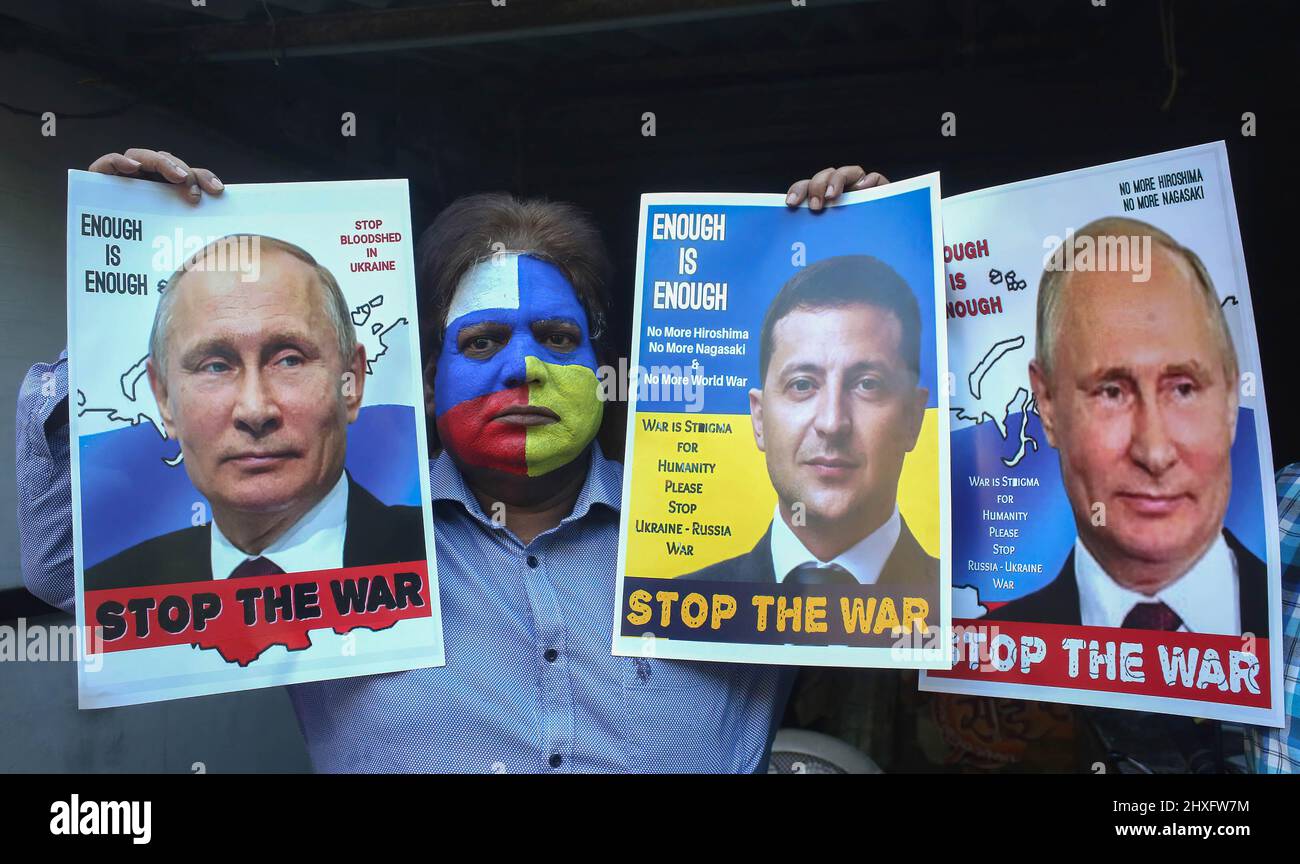 Bhopal, India. 12th Mar, 2022. A peace campaigner with his face painted with the colors of the national flags of Russia and Ukraine, holds portraits of Russian President, Vladimir Putin and Ukrainian President, Volodymyr Zelensky making an appeal to stop war. Russia began an invasion of Ukraine on Feb, 22, 2022 which is said to be the largest conventional military attack in Europe since World War II. Credit: SOPA Images Limited/Alamy Live News Stock Photo
