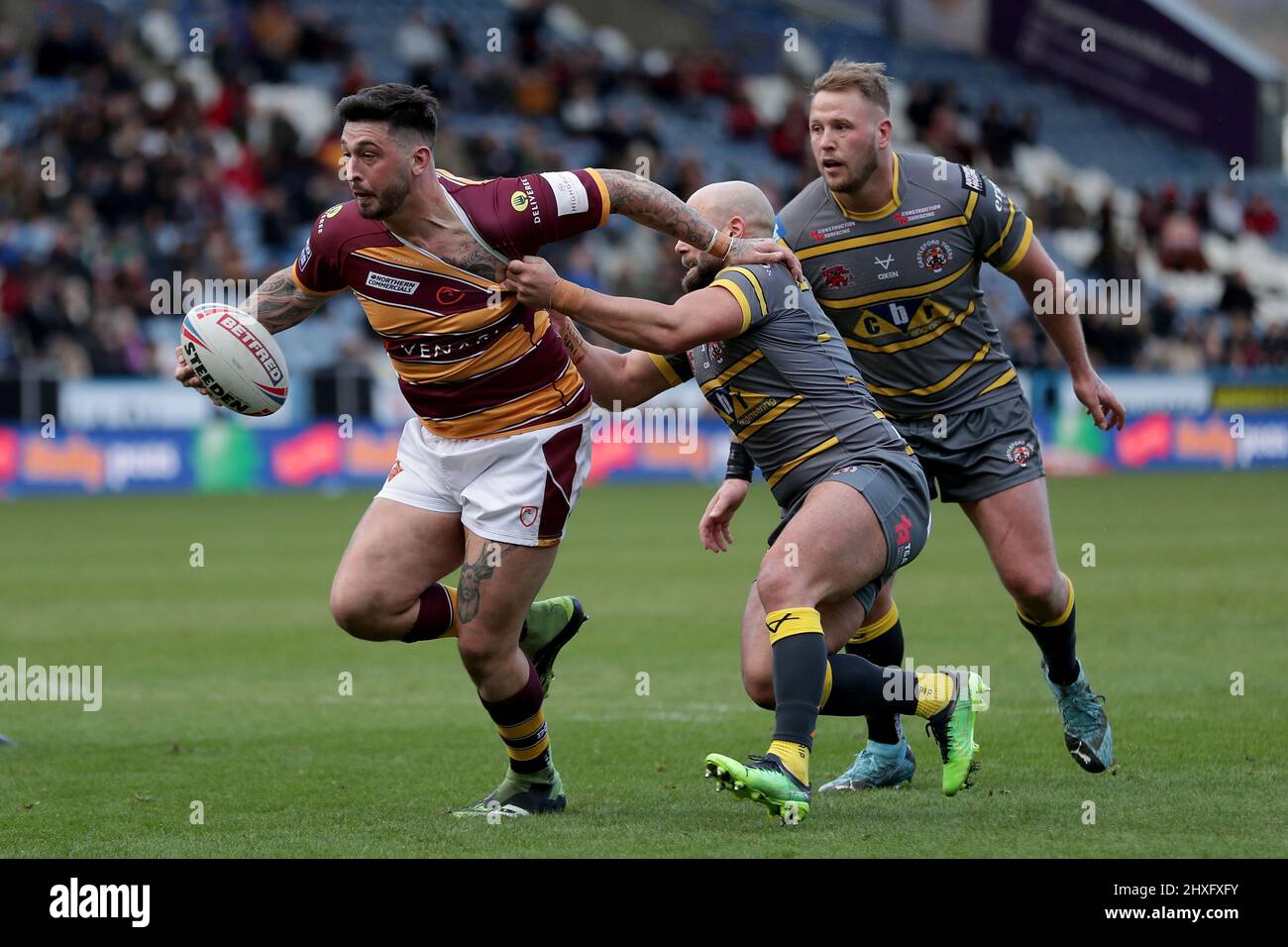 Huddersfield giants Ollie Roberts is held back by Castleford Tigers Paul Mcshane during the Betfred Super League match at The John Smith's Stadium, Huddersfield. Picture date: Saturday March 12, 2022. Stock Photo