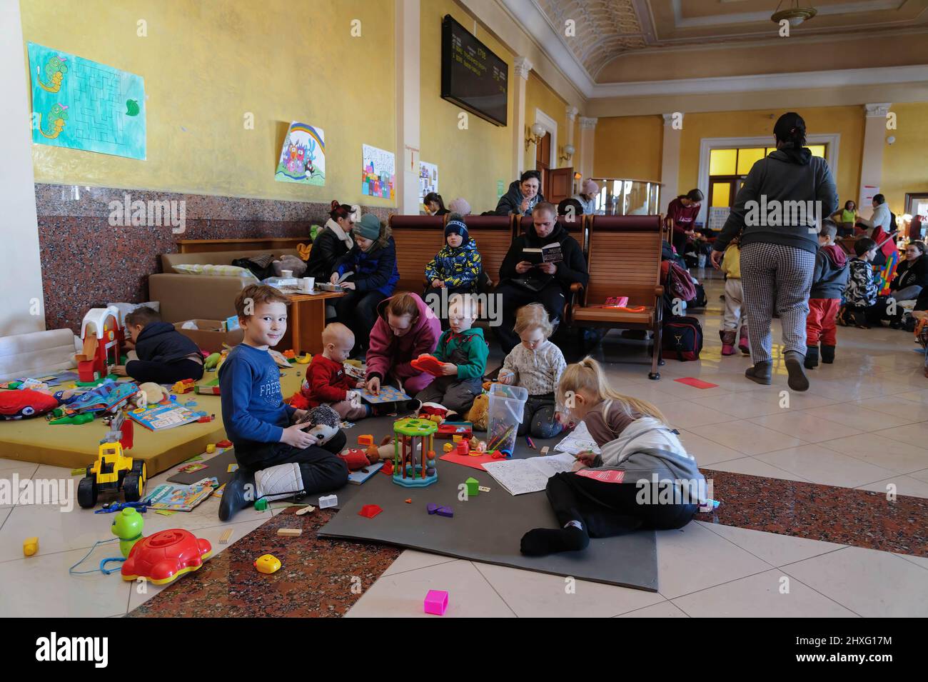 Children seen in a room for women and children who fled the Russian invasion in the VIP room at the railway station in Lviv. Russian troops entered Ukraine on 24 February. Stock Photo