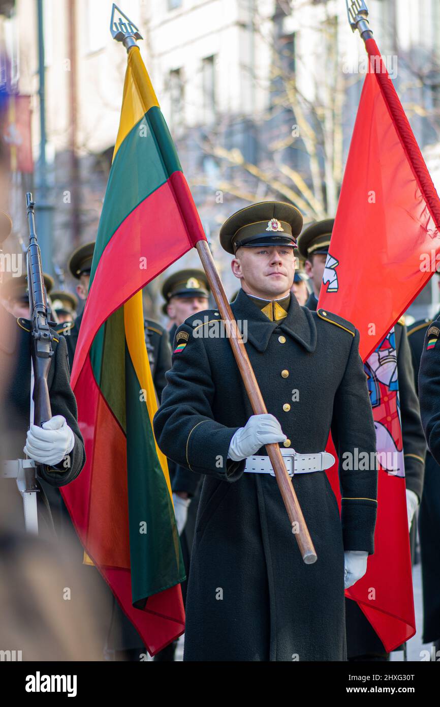 Soldier in official uniforms marching through the streets of the capital Vilnius, Lithuania with national flags, March 11 Independence Day, close up Stock Photo