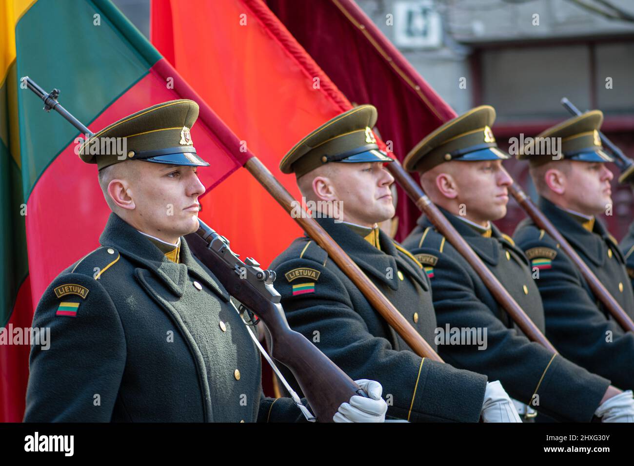 Soldiers in official uniforms marching through the streets of the capital Vilnius, Lithuania with national flags, March 11 Independence Day, close up Stock Photo