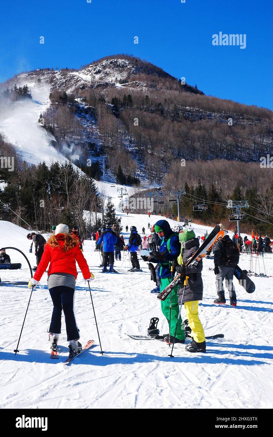Skiers prepare themselves to take on the highest peak at a resort Stock Photo