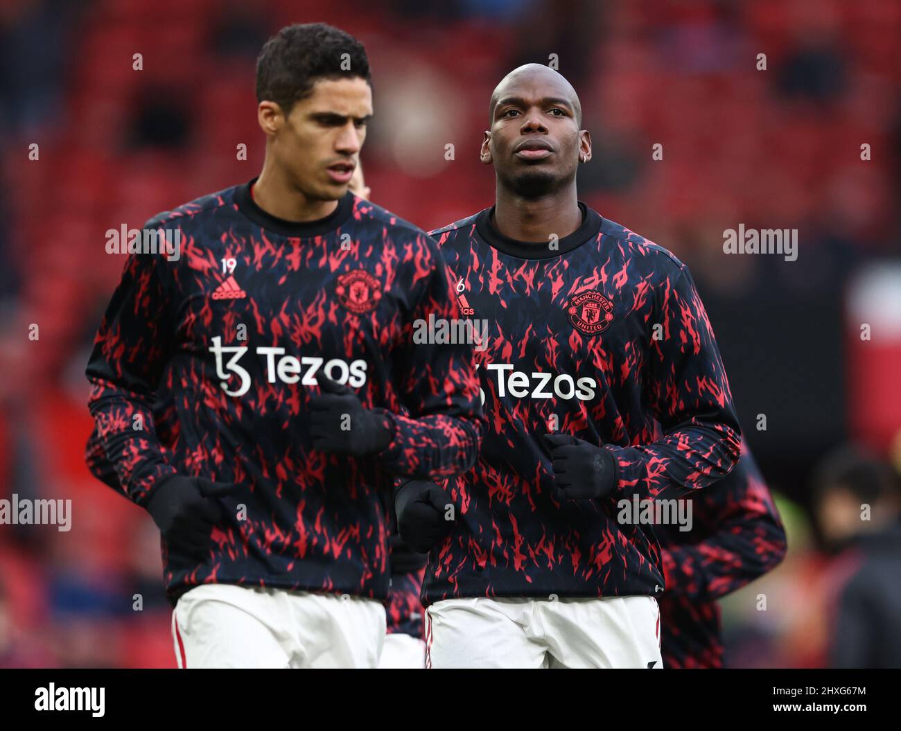 Manchester, England, 12th March 2022.   Paul Pogba of Manchester United warms up with his hair shaved off  during the Premier League match at Old Trafford, Manchester. Picture credit should read: Darren Staples / Sportimage Stock Photo