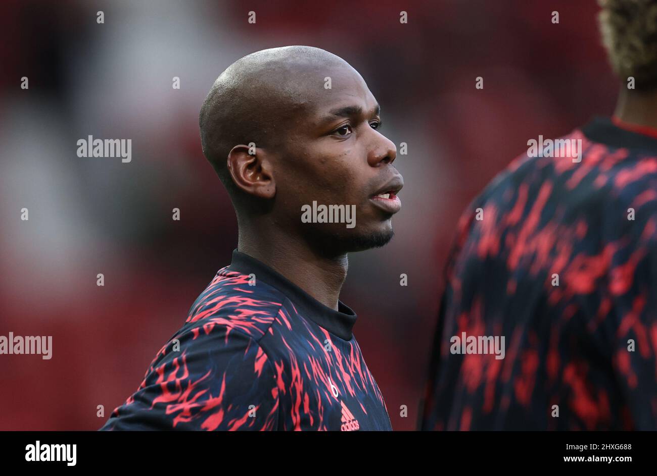 Manchester, England, 12th March 2022.   Paul Pogba of Manchester United warms up with his hair shaved off  during the Premier League match at Old Trafford, Manchester. Picture credit should read: Darren Staples / Sportimage Stock Photo