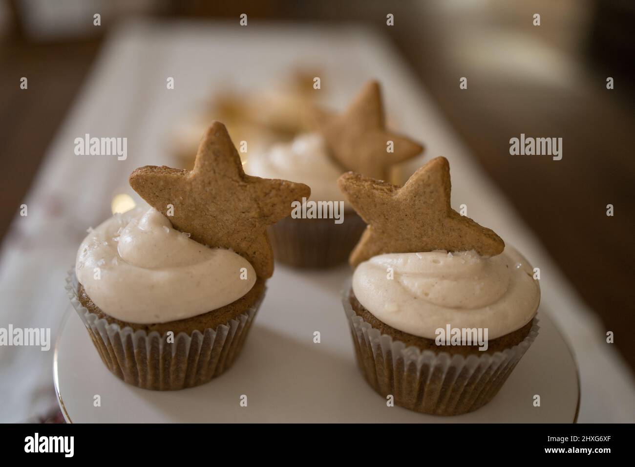 Cupcakes with gingerbread star cookie on white ceramic stand Stock Photo