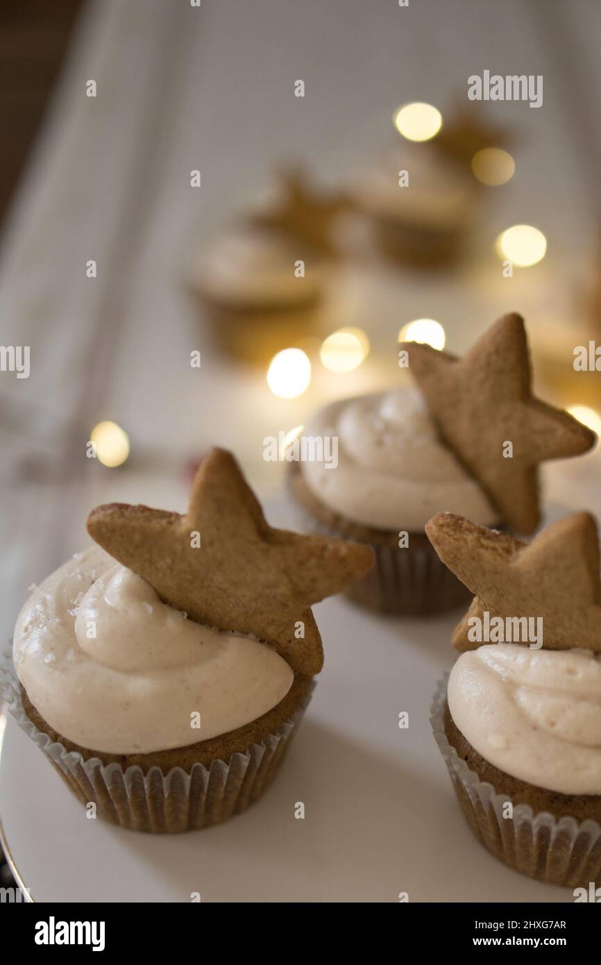 cupcakes with star cookie on white tablecloth with lights Stock Photo