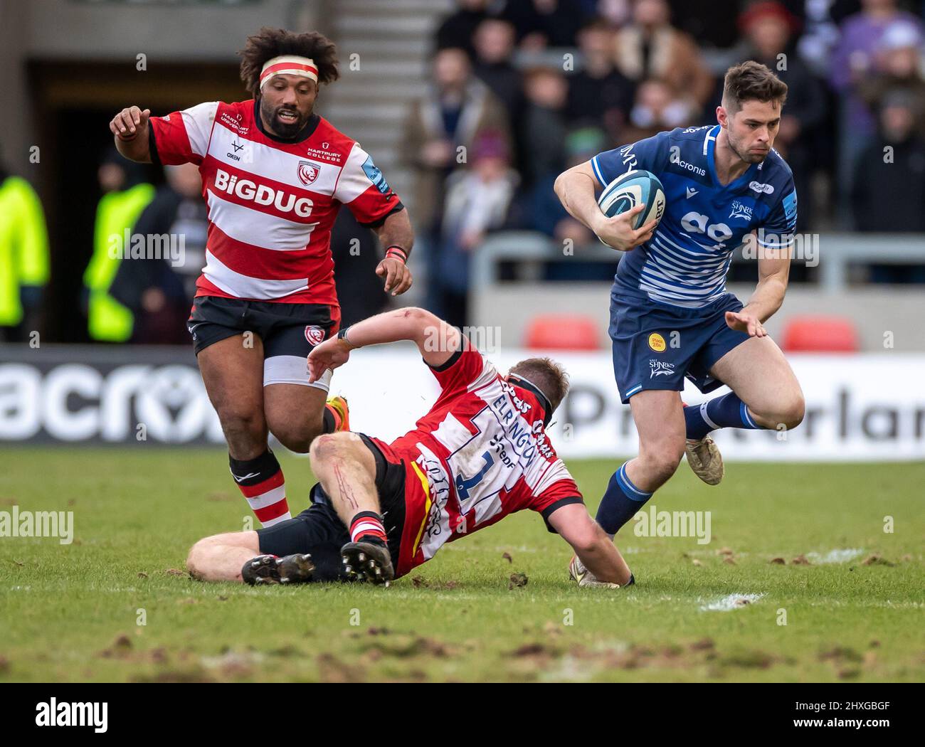 12th March 2022 ; AJ Bell Stadium, Sale, England; Gallagher Premiership rugby, Sale versus Gloucester:  Luke James of Sale Sharks slips the tackle of  Harry Elrington of Gloucester Stock Photo