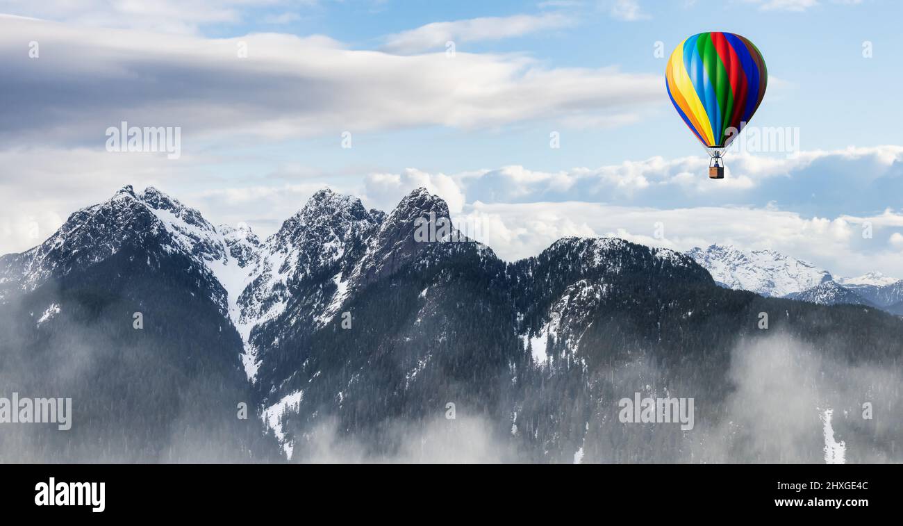 Dramatic Mountain Landscape covered in clouds and Hot Air Balloon ...