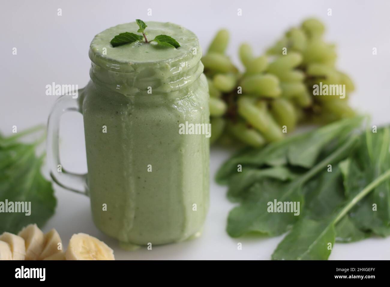 Green smoothie made of frozen green grapes, fresh baby spinach, bananas