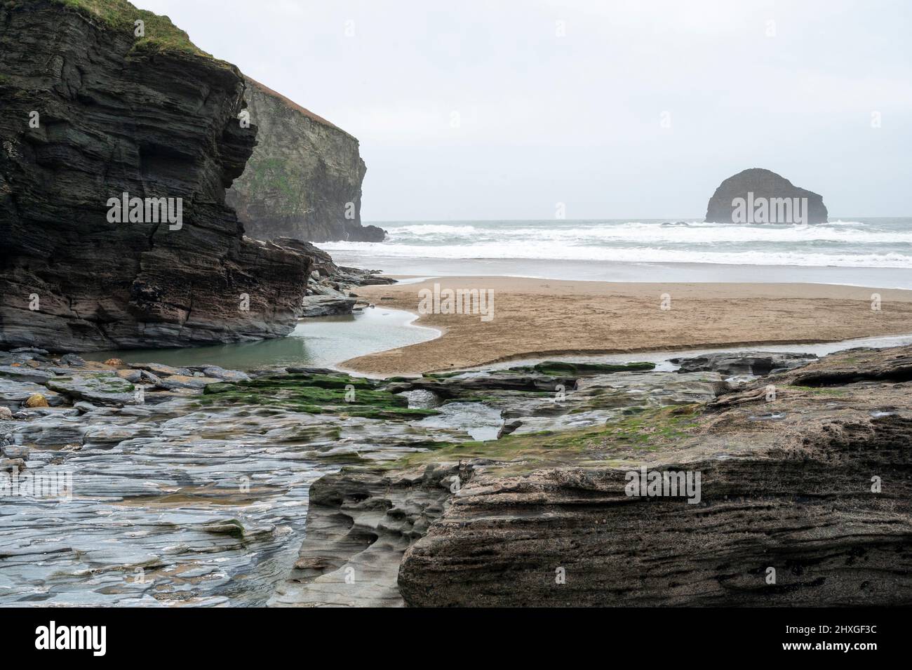 Trebarwith Strand beach in winter with Gull Rock Island, cliffs and empty beach. Stock Photo