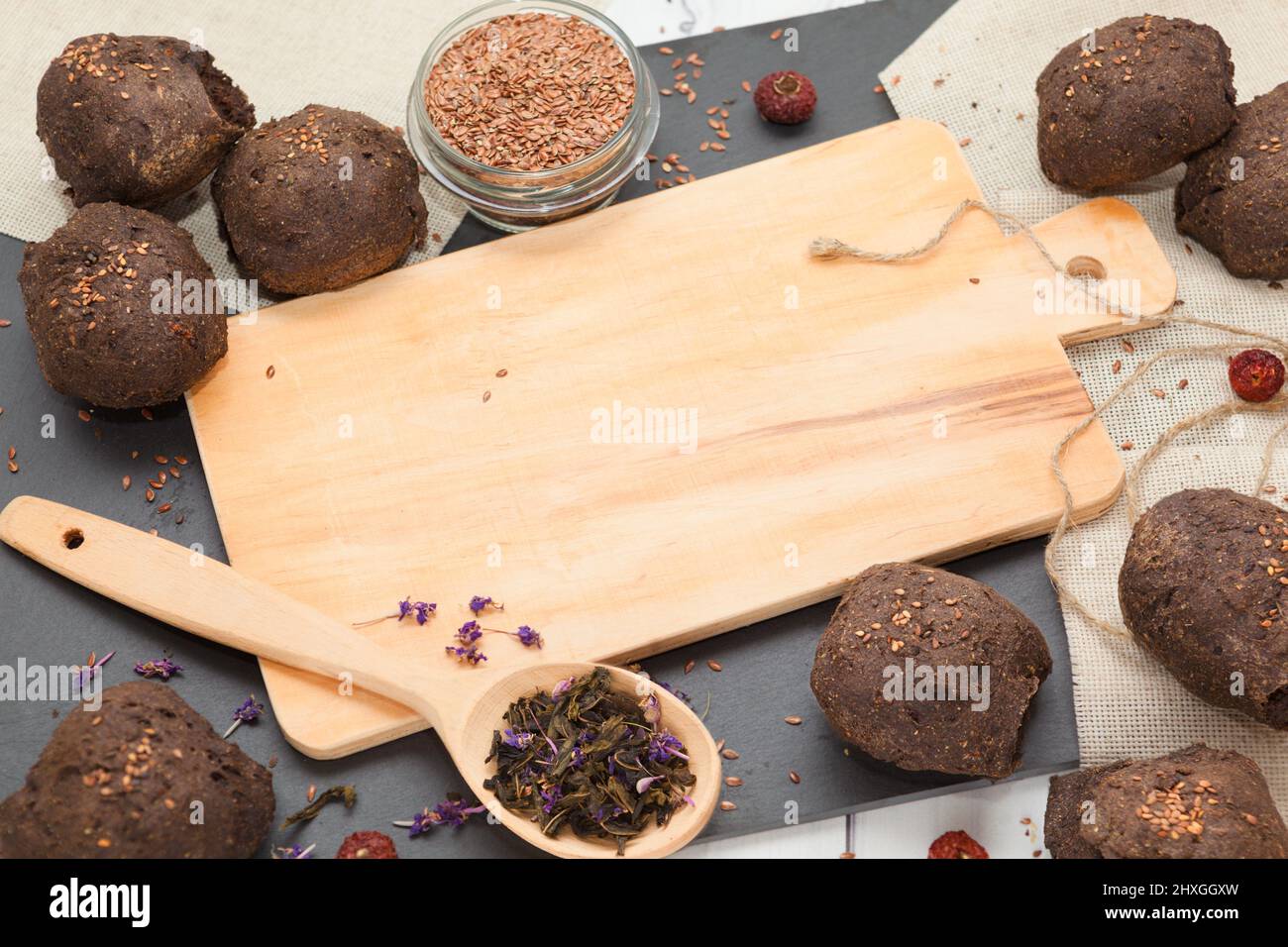 Homemade dietary flax bread buns with trencher close up view Stock Photo