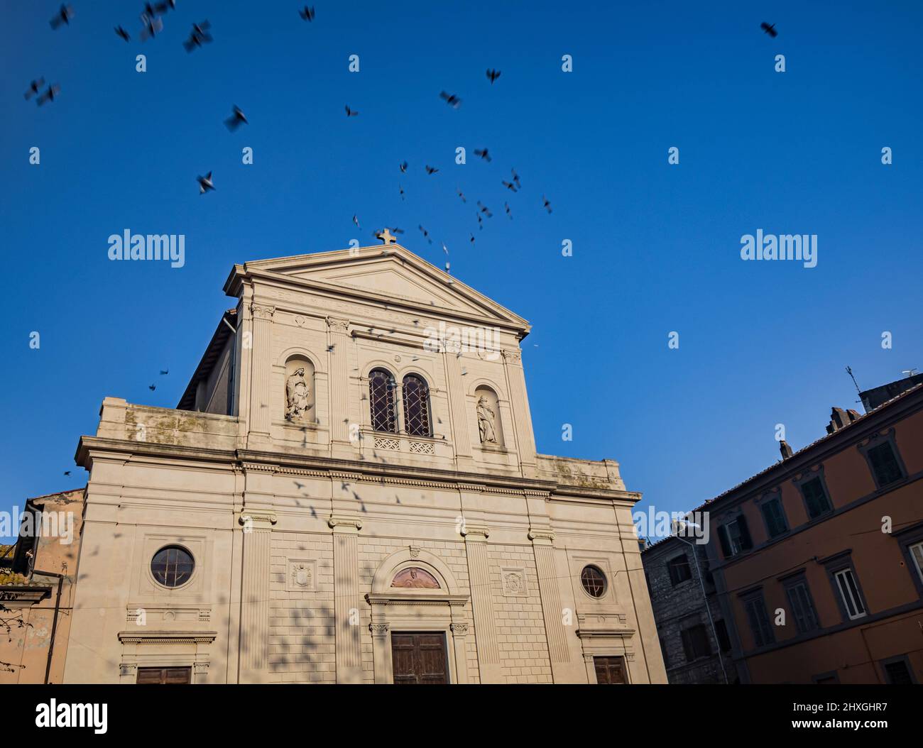 The village of Tarquinia, Viterbo, Lazio, Italy - The facade of the church of Saints Margherita and Martino. The mullioned window in the center and th Stock Photo