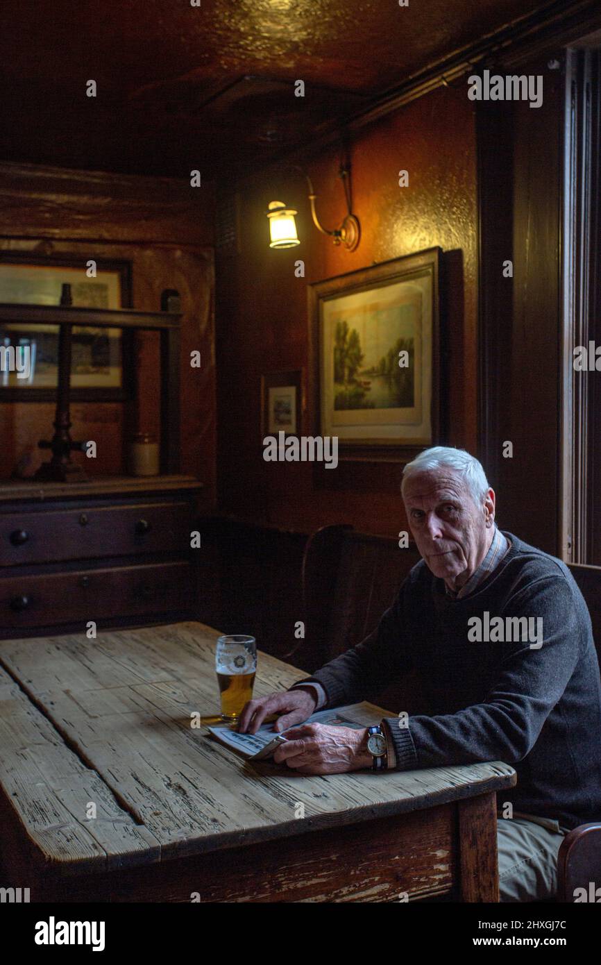 Elderly man drinking pint of lager in pub The White Horse Inn - aka Nellies, Beverly ,Yorkshire,United Kingdom. Stock Photo