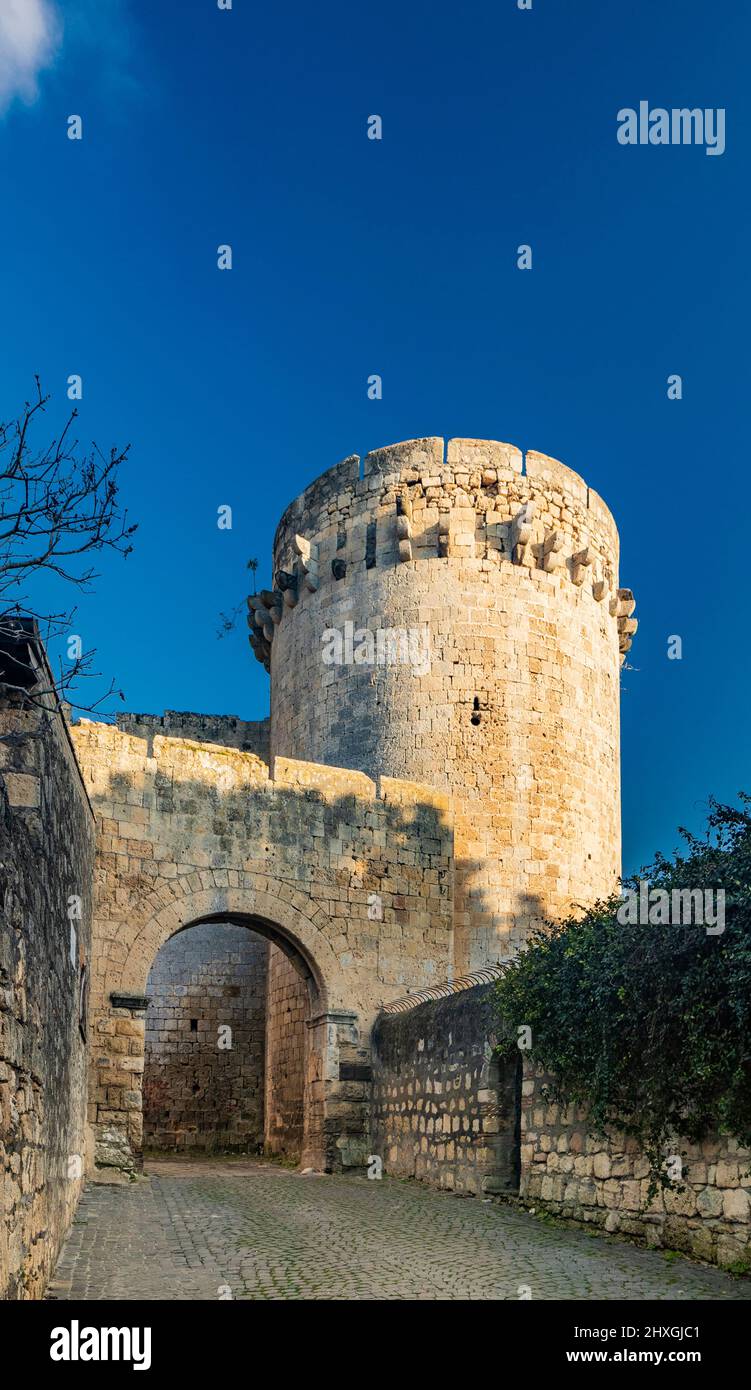 The village of Tarquinia, Viterbo, Lazio, Italy - Porta di Castello, the access arch through the ancient defensive walls of the city, with the large c Stock Photo
