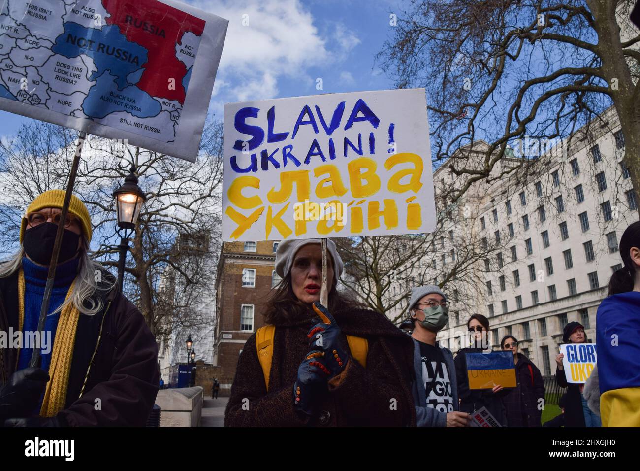 London, UK. 12th March 2022. A protester holds a 'Slava Ukraini (Glory To  Ukraine)' placard. Protesters gathered outside Downing Street in support of  Ukraine as Russia continues its attack. Credit: Vuk Valcic/Alamy