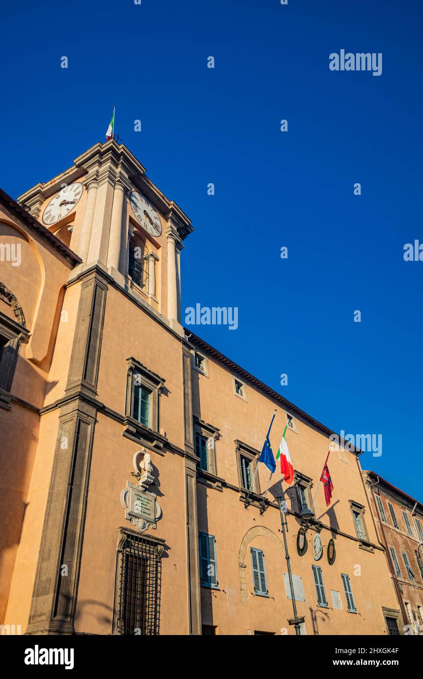 Feb.6, 2022 - Tarquinia, Viterbo, Lazio, Italy - The main square of the village. The town hall illuminated by the sun, in the blue sky. Tower with the Stock Photo