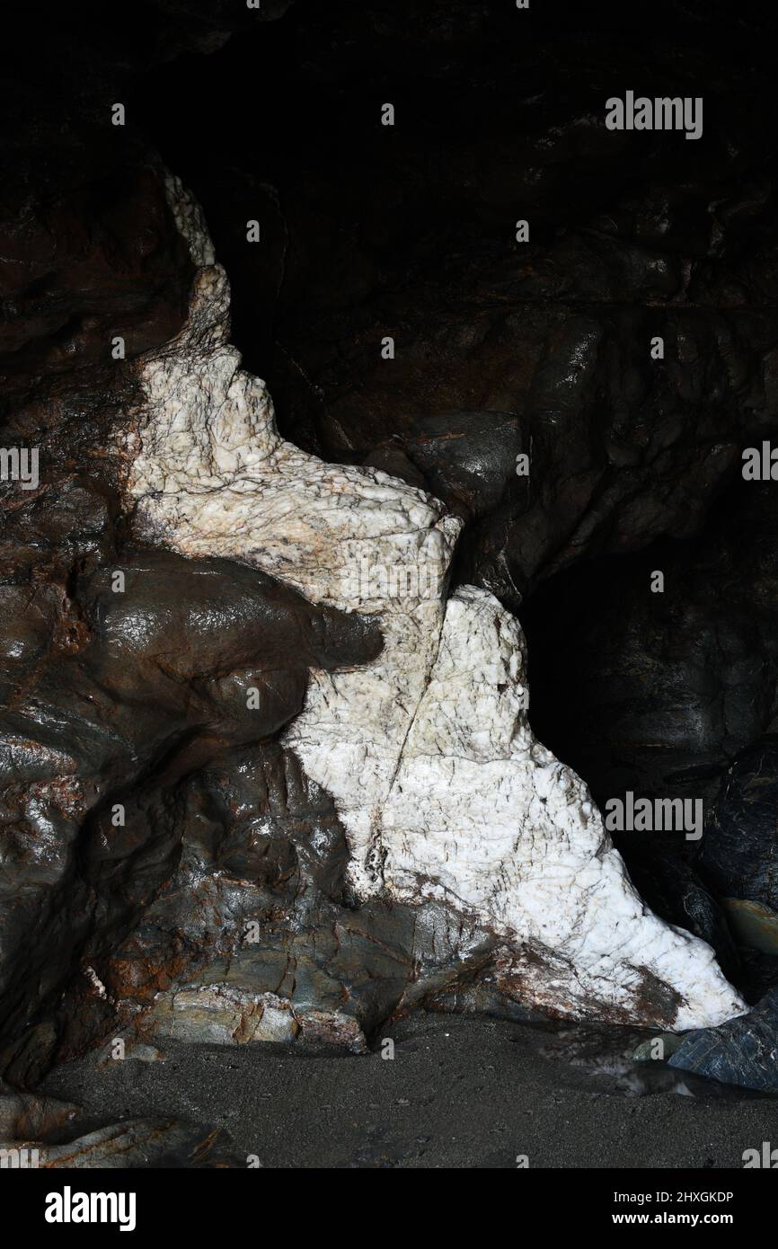 Quartzite in a sea cave at Tregardock Beach Cornwall Stock Photo
