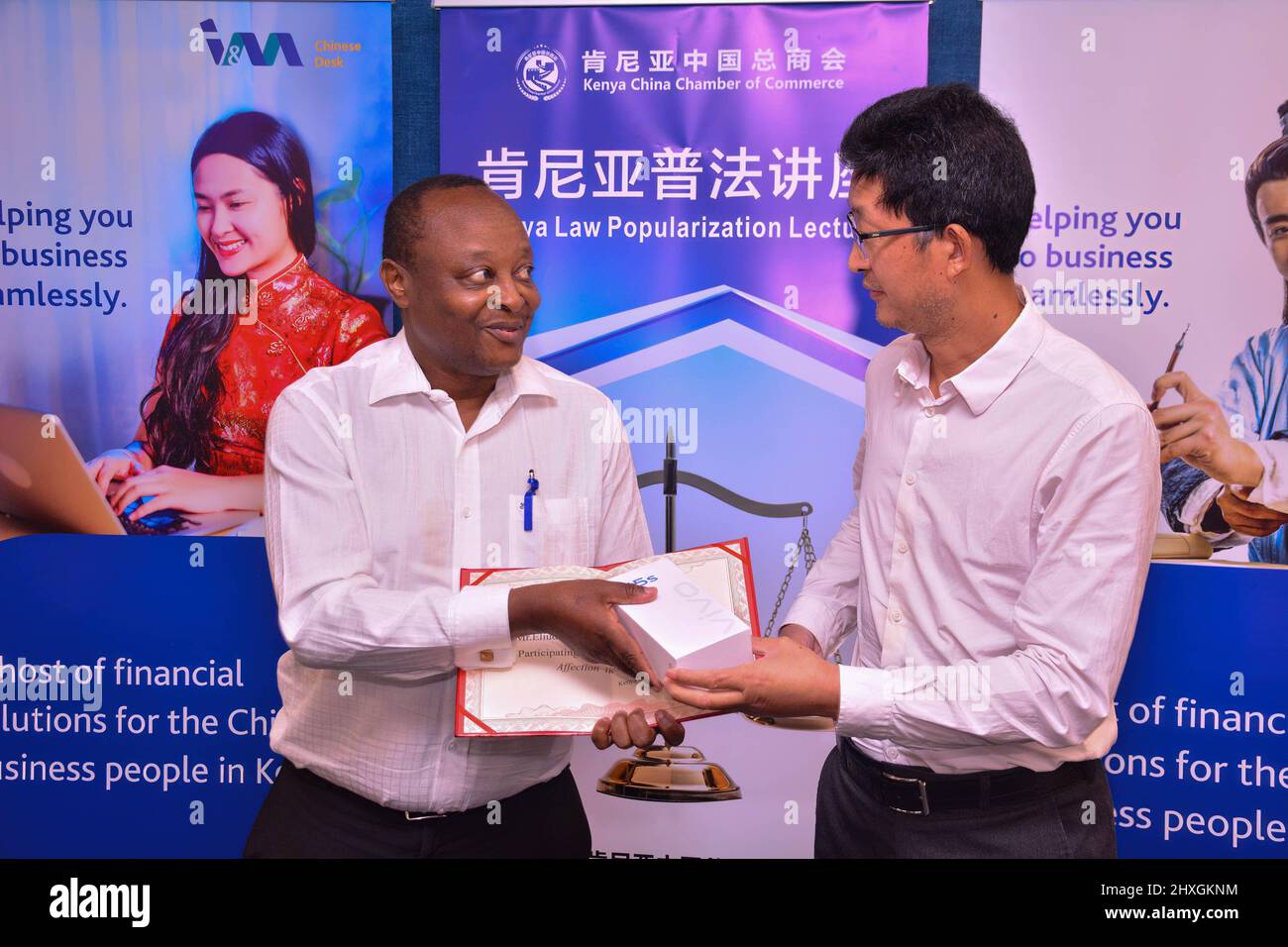 Nairobi, Kenya. 12th Mar, 2022. Eliud Ngige of Kenya China Chamber of Commerce receives an award from Chairman of Kenya Jiangsu Business Association Yongwei Xiong during a workshop held in Nairobi to familiarize Chinese investors with Kenyan Law. Credit: SOPA Images Limited/Alamy Live News Stock Photo