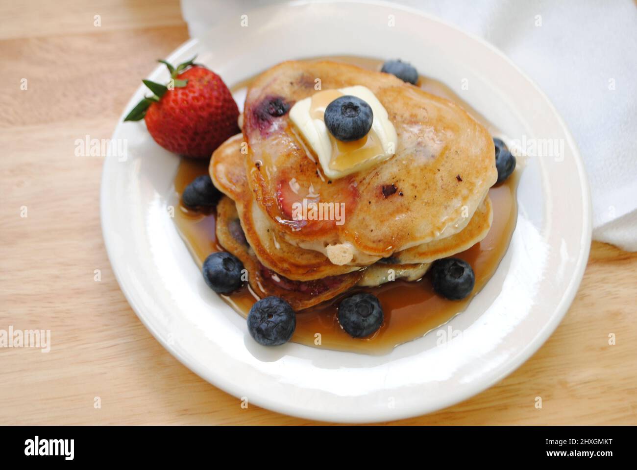 Healthy Strawberry and Blueberry Pancakes Served with Syrup Stock Photo