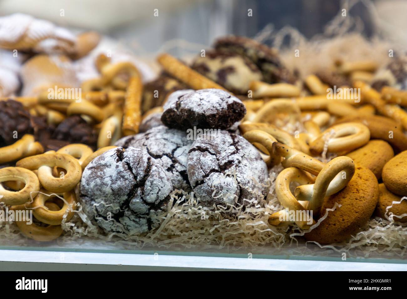 Various cookies and pastries are in the window of the confectionery shop Stock Photo