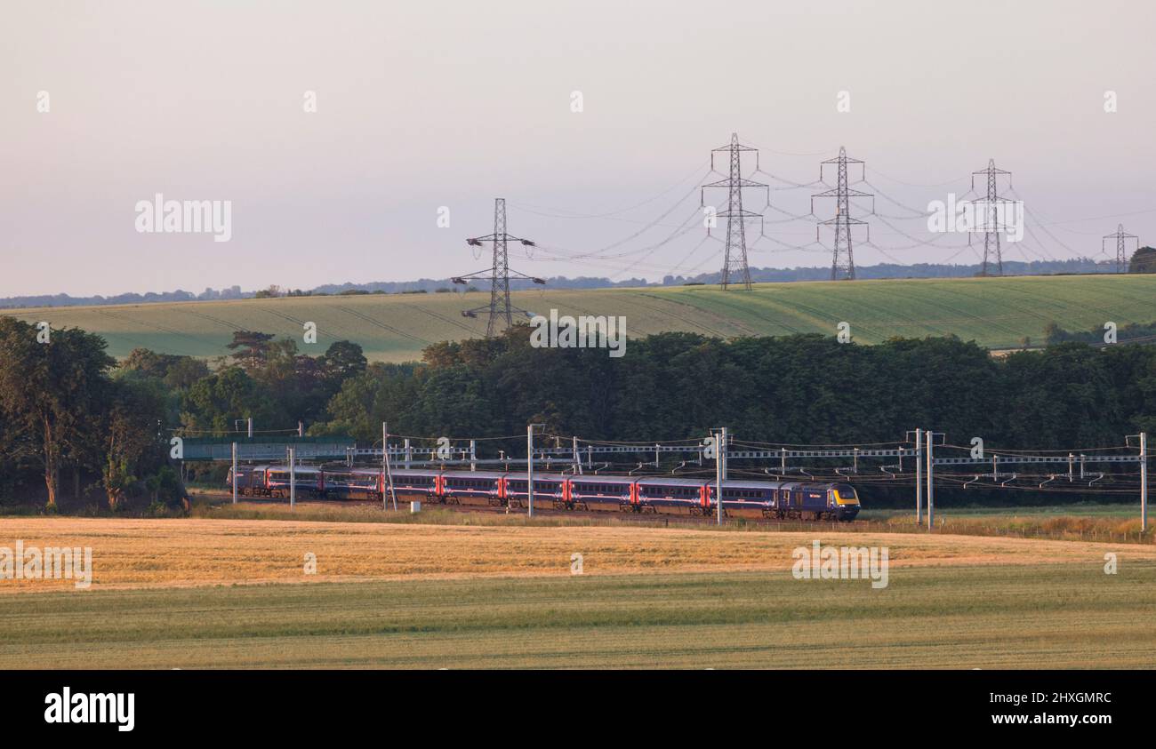 First Great western High speed train passing Cholsey Manor farm on the electrified Great Western mainline early on a mid summer morning Stock Photo