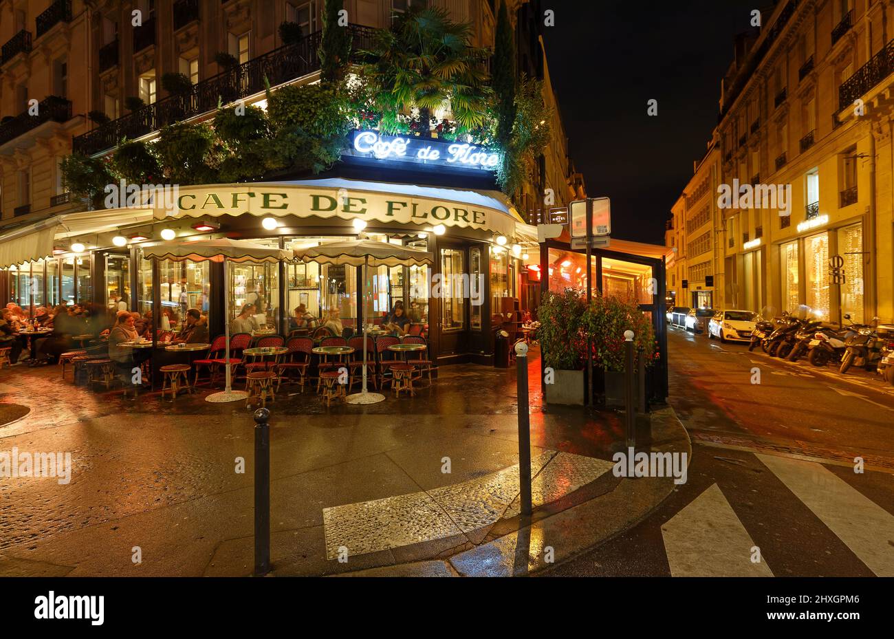 The famous cafe Les de Flore at rainy evening . It located on Saint-Germain boulevard . Stock Photo