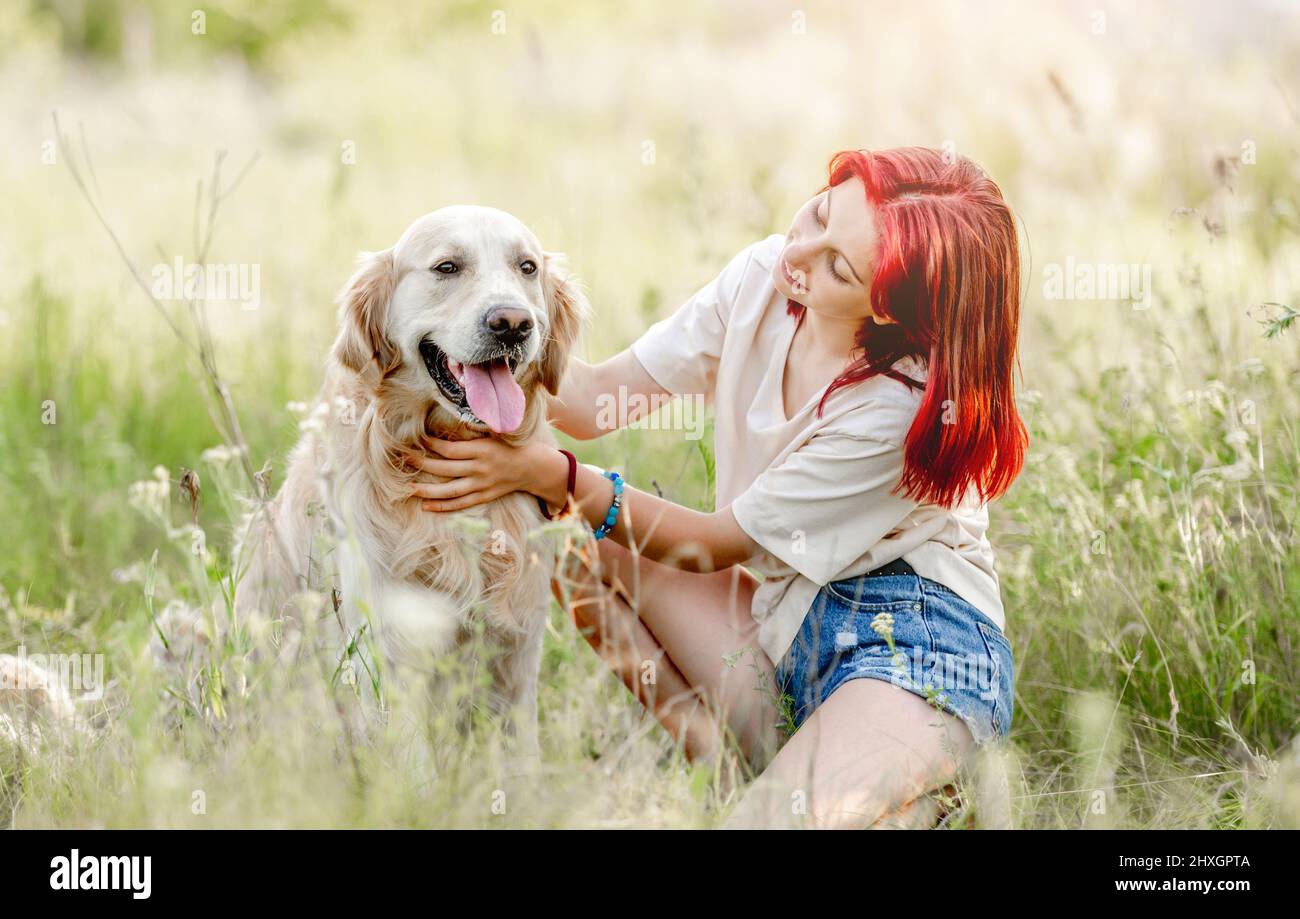 Teen girl with golden retriever dog Stock Photo - Alamy