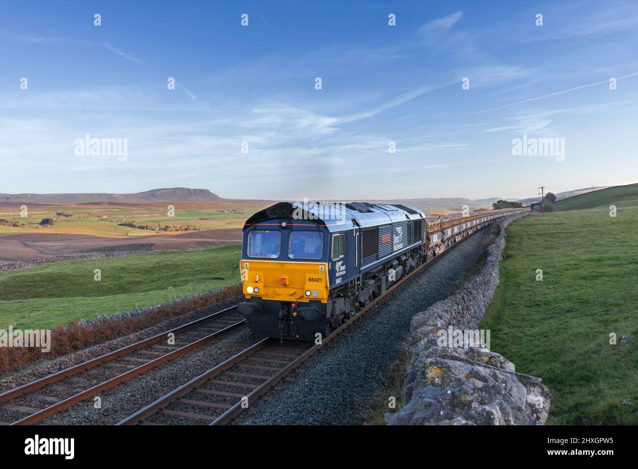 Direct rail Services class 66 locomotive at Ribblehead on the Settle  to Carlisle line with a freight train carrying railway ballast for Network Rail Stock Photo