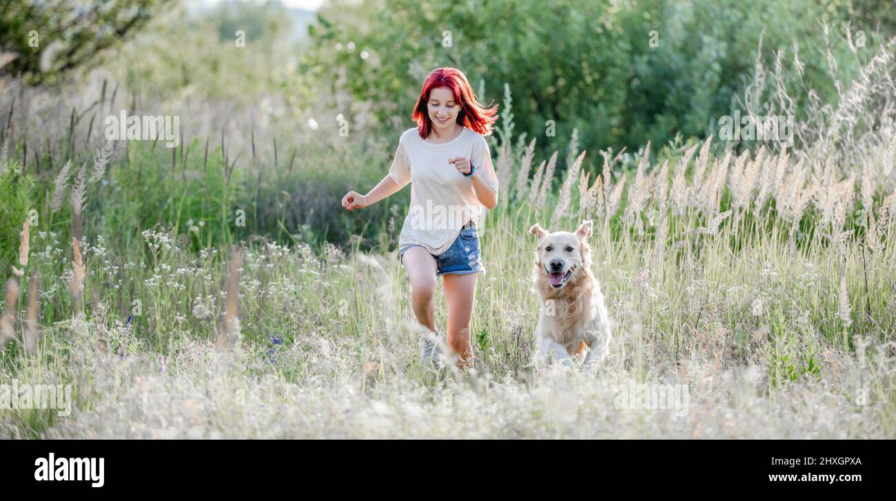Teen girl with golden retriever dog Stock Photo - Alamy