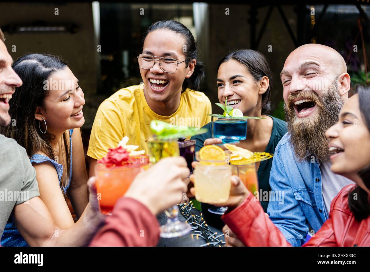 Millennial people having fun while social gathering together at weekend party Stock Photo