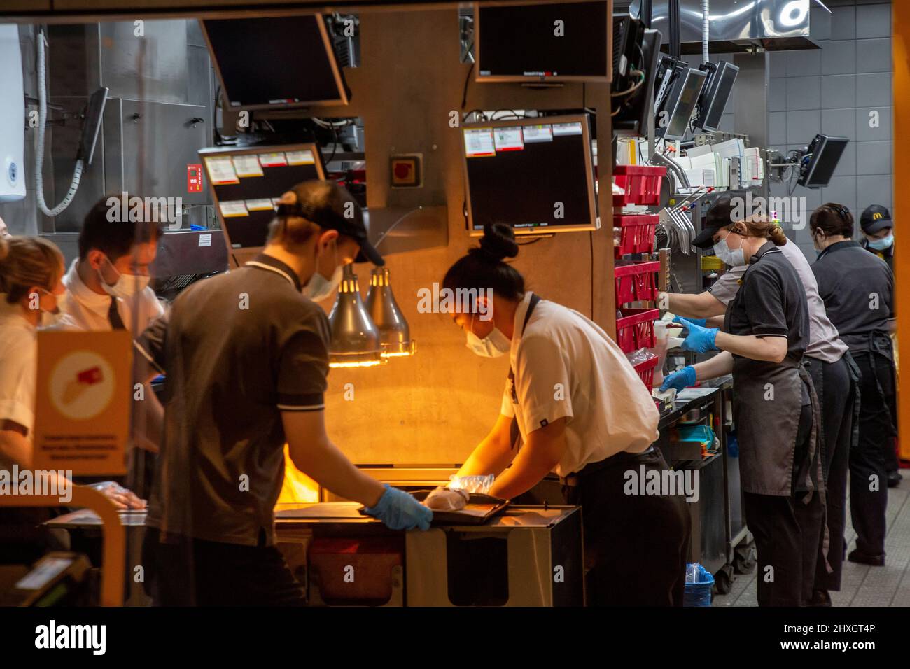 Moscow, Russia. 12th of March, 2022 Employees of the McDonald's restaurant chain are preparing a food in the restaurant on Tverskaya street in central Moscow, Russia. On March 8, 2022, the American fast food chain announced its plans to temporarily close its 850 Russian restaurants from March 14 Stock Photo