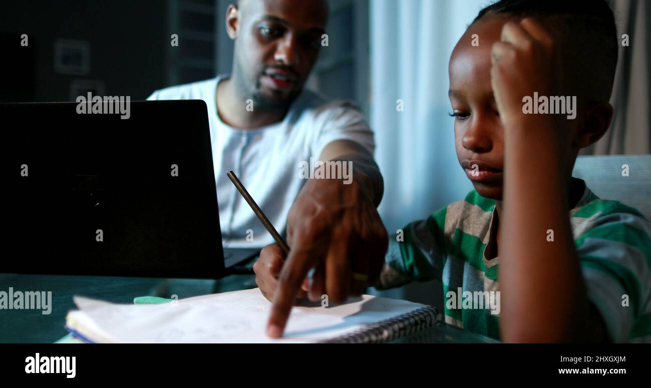 Father multi-tasking using computer laptop at home. Candid authentic ...
