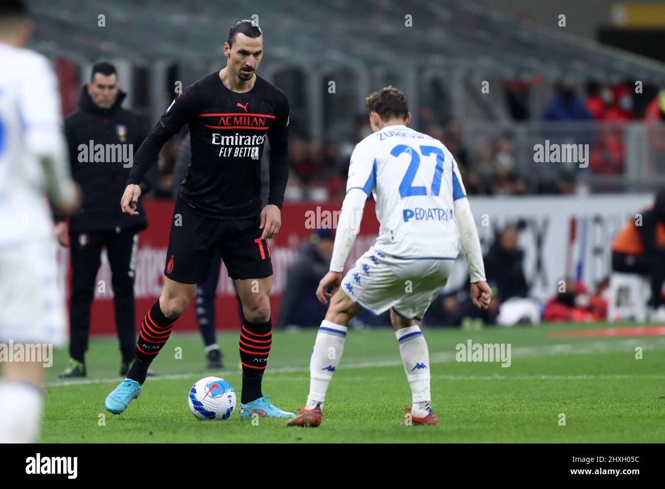 Zlatan Ibrahimovic of Ac Milan and Szymon Zurkowskof Empoli Fc  battle for the ball during the Serie A match between Ac Milan and Empoli Fc at Stadio Giuseppe Meazza on March 12, 2022 in Milan, Italy. Stock Photo