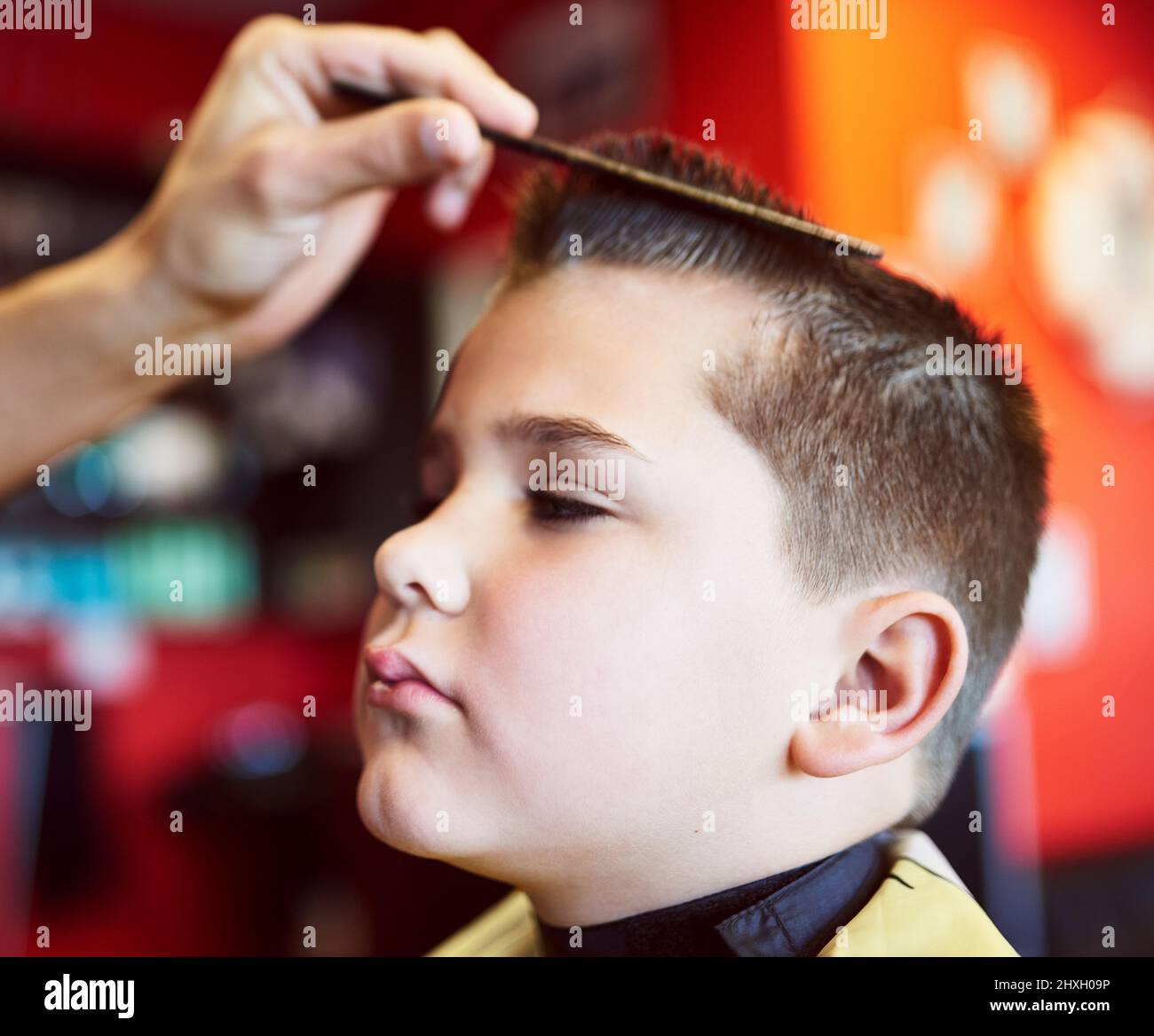 Looking good. Closeup shot of a young boy getting a haircut at a barber shop. Stock Photo
