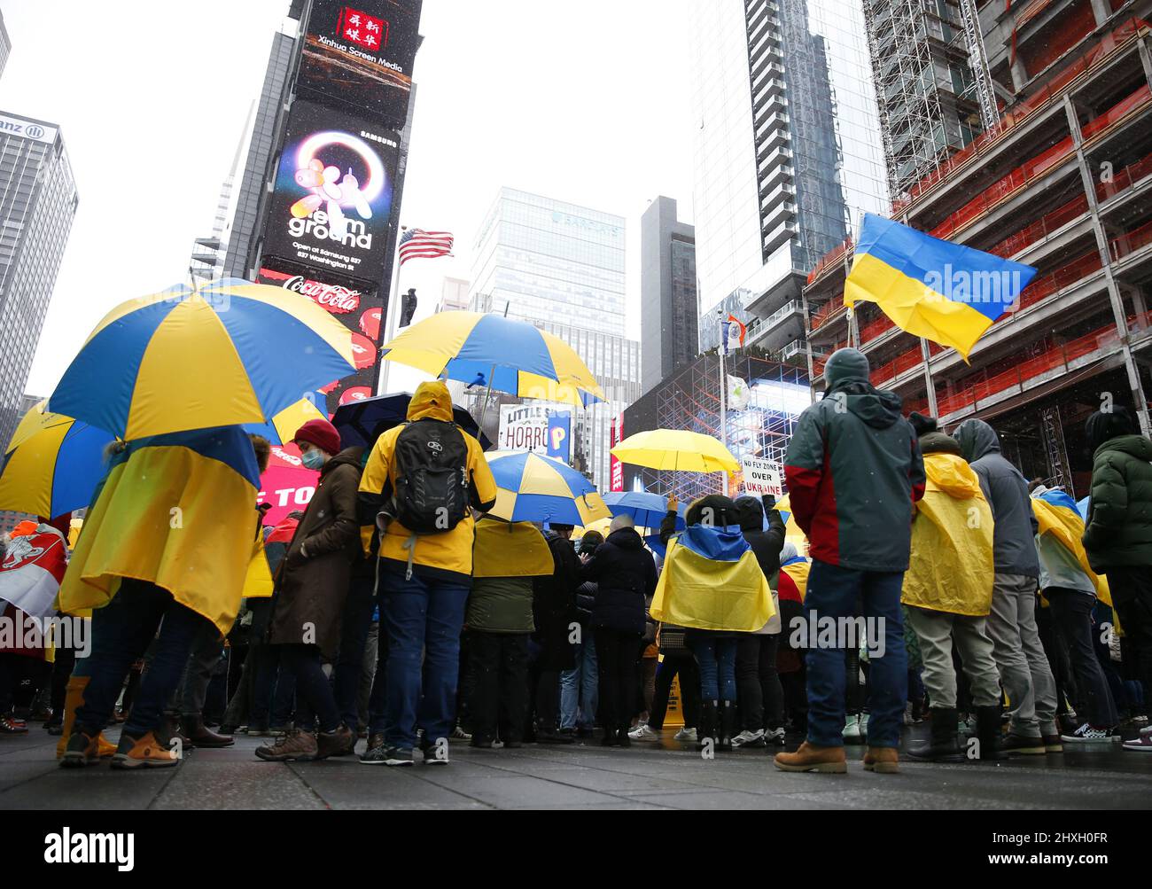 New York, United States. 12th Mar, 2022. Protesters hold umbrellas with