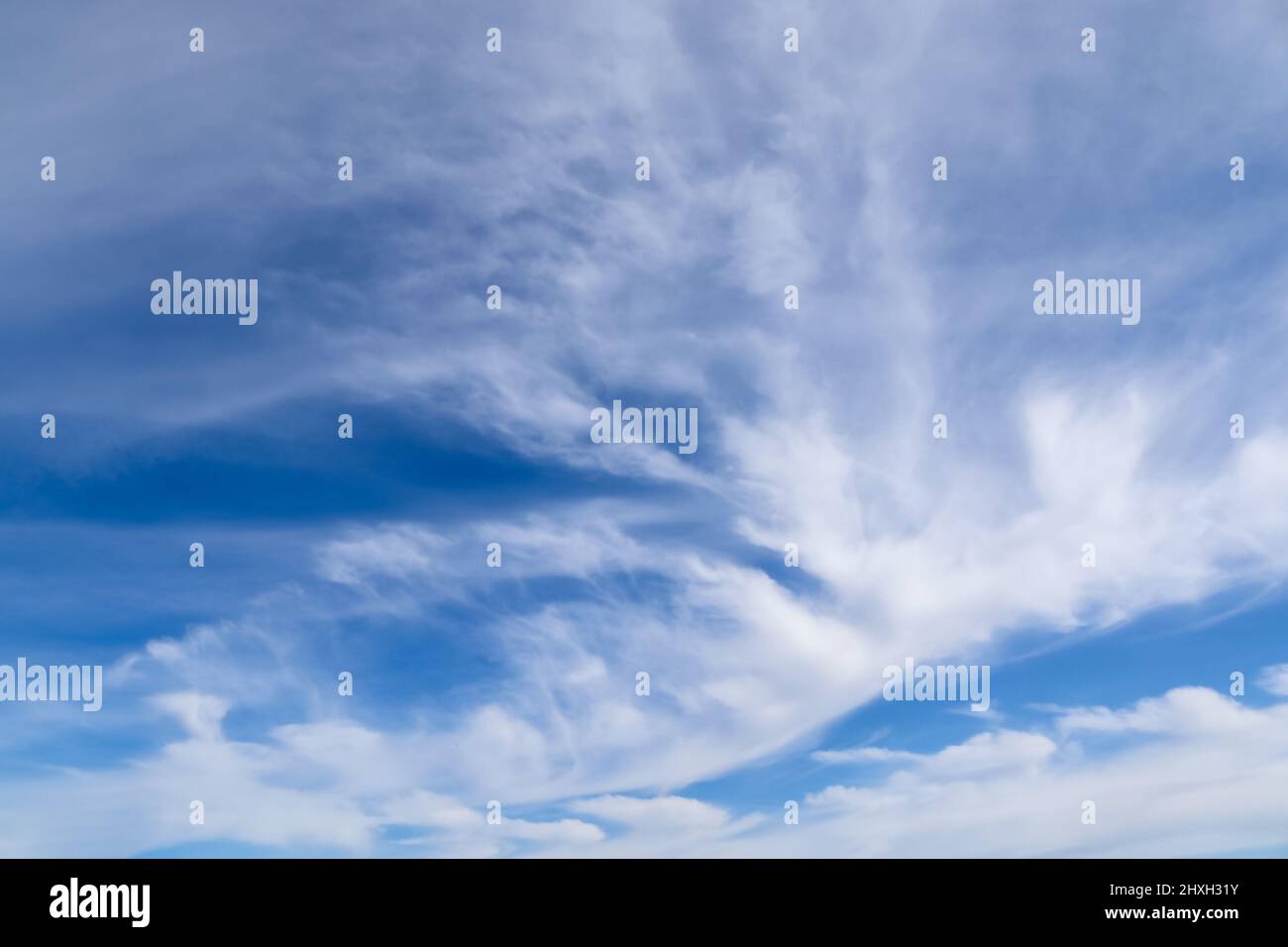 Stunning cirrus cloud formation panorama in a deep blue summer sky seen ...
