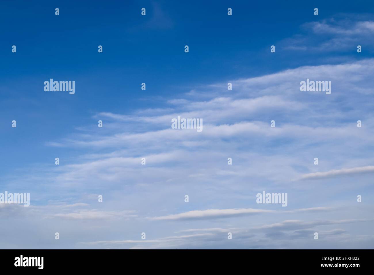 Stunning cirrus cloud formation panorama in a deep blue summer sky seen ...