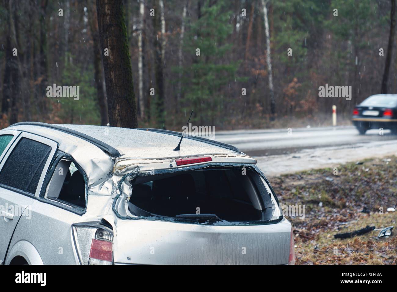 Passenger passing highway traffic by a wrecked accident family suv