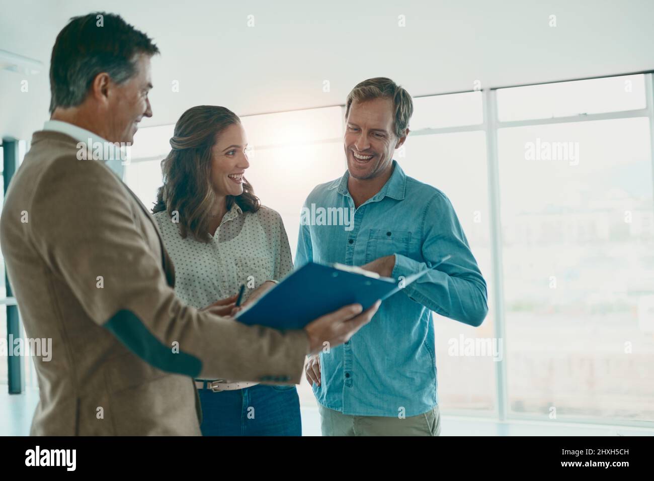 The excitement grows. Shot of a group of businesspeople discussing ideas in the new office space for the business and future. Stock Photo