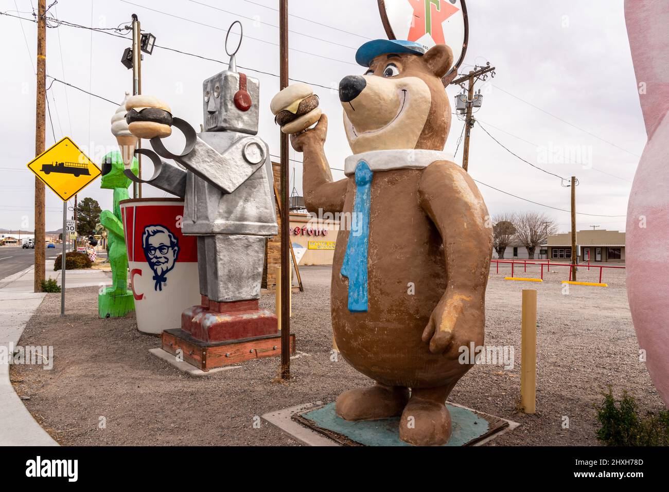 Pop culture fiberglass statues, Yogi Bear, a robot, KFC bucket and green alien, alongside the highway in Hatch, New Mexico. Stock Photo