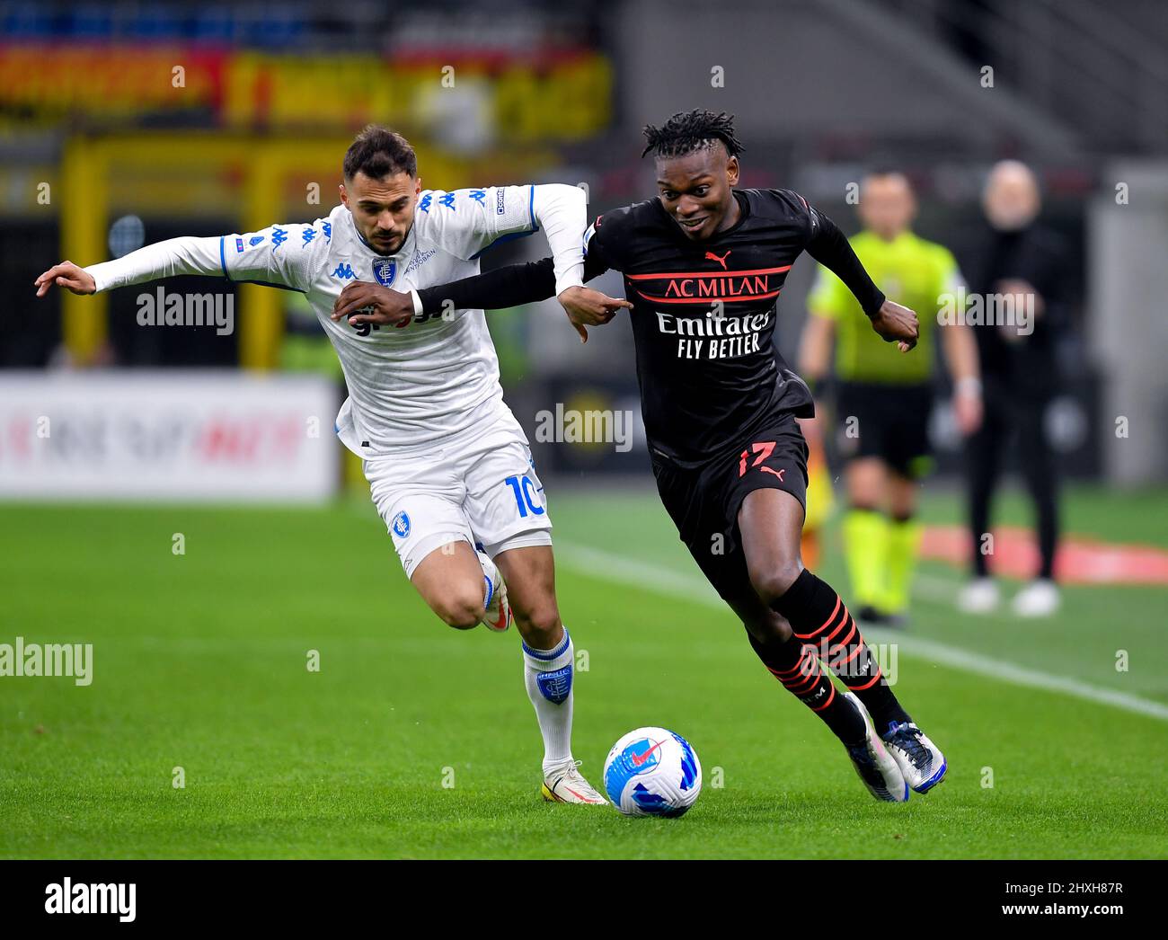 Milan, Italy. 12th Mar, 2022. AC Milan's Rafael Leao (R) vies with Empoli's Nedim Bajrami during a Serie A football match between AC Milan and Empoli in Milan, Italy, on March 12, 2022. Credit: Alberto Lingria/Xinhua/Alamy Live News Stock Photo