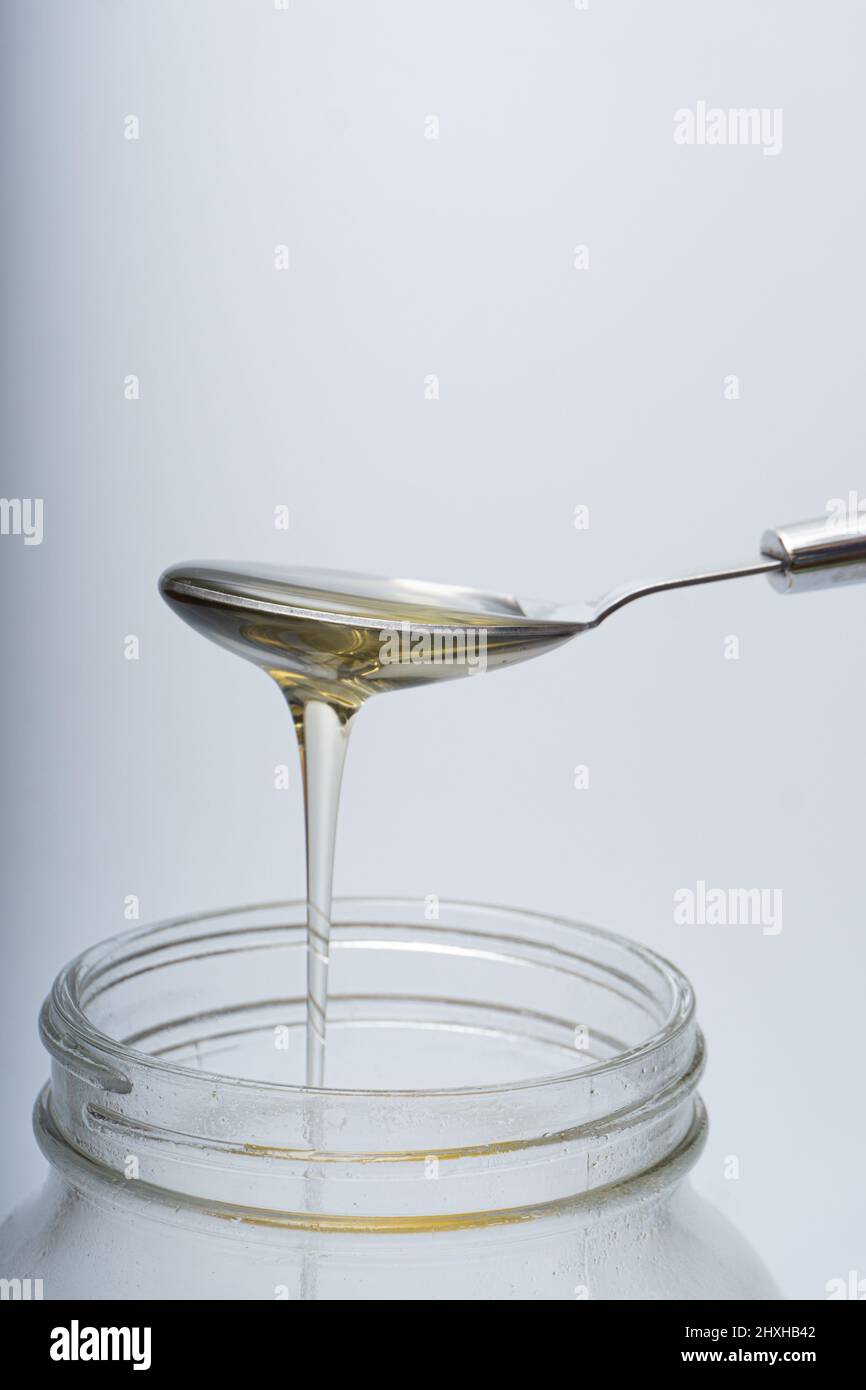 Concept of spooning honey from a bottle Stock Photo Alamy