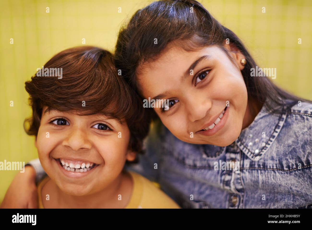 Best friends for a lifetime. Portrait of two siblings standing together indoors. Stock Photo