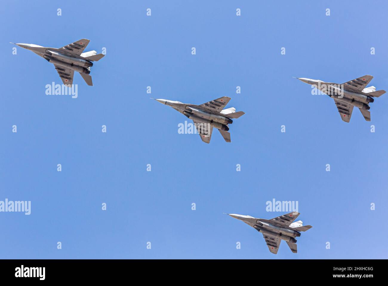 combat fighter jet on a military mission. attack aircrafts flying on blue sky background. Stock Photo