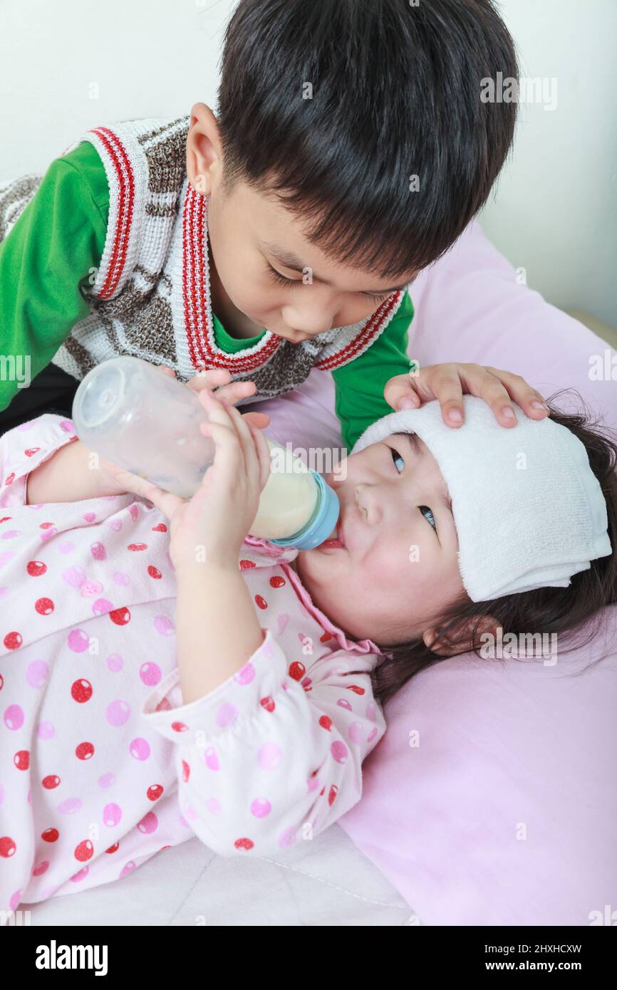 https://c8.alamy.com/comp/2HXHCXW/sick-sister-lying-and-suck-up-milk-on-the-bed-kindly-brother-keep-vigil-over-a-sick-of-closely-conceptual-image-about-loving-and-bonding-of-sibling-2HXHCXW.jpg