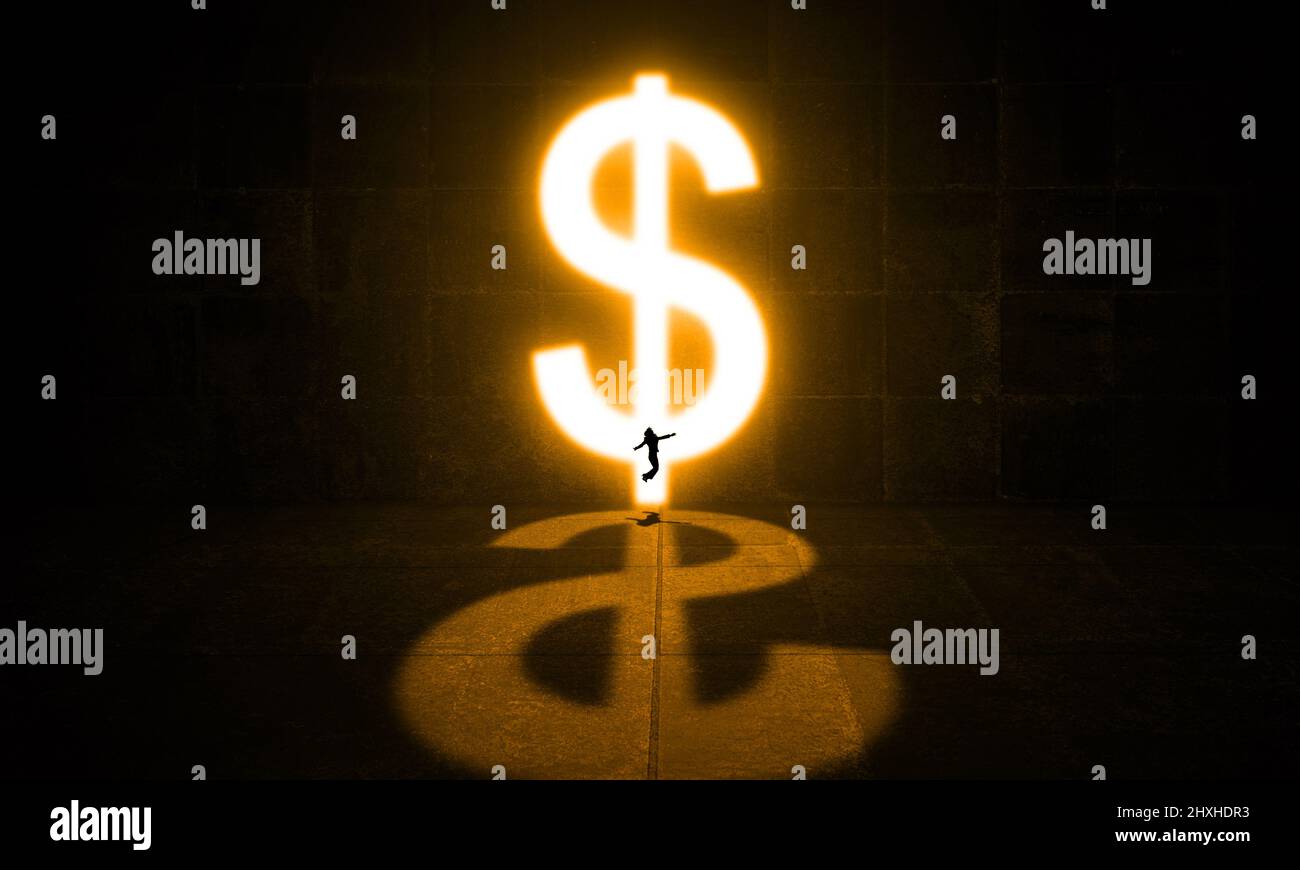 Jumping Businessman in dark Concrete Room with a Door Light made of Bright Dollar Sign Business man Finance and Financial Freedom Concept Stock Photo