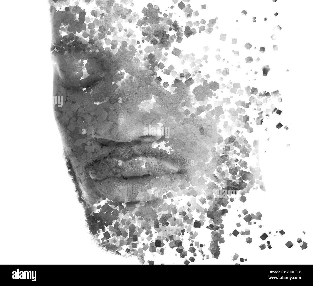 A portrait of a young man dissolving into countless particles. Stock Photo