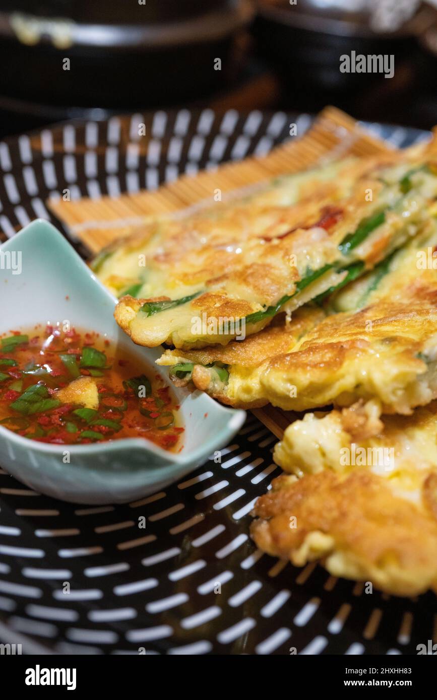 korean seafood pancake with sauce, closeup shot. Stock Photo