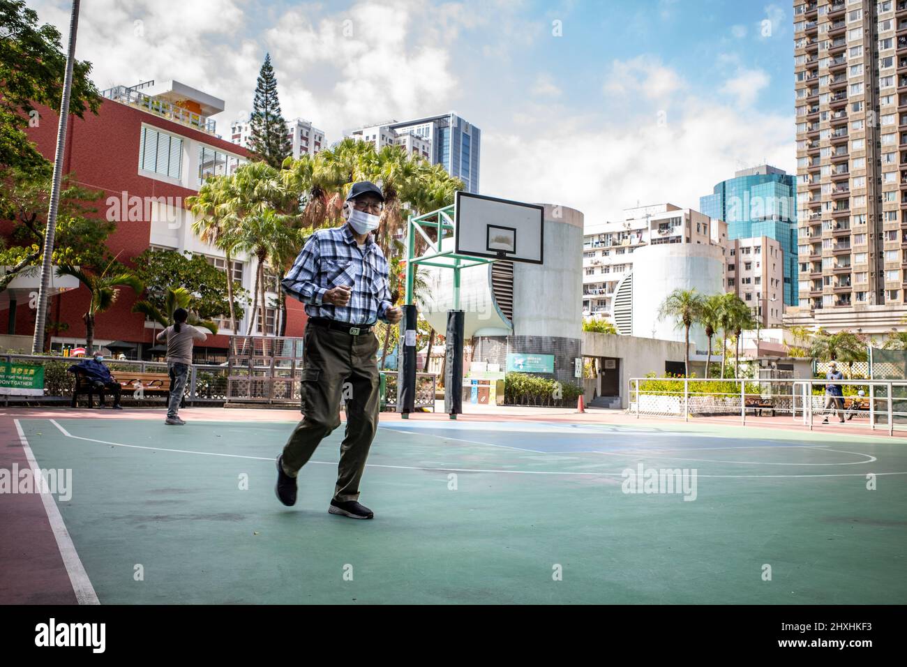Hong Kong. 01st Mar, 2022. An elderly Hongkonger does laps around an empty basketball court in North Point. In light of the increased cases in Hong Kong, the Leisure and Cultural Services Department has closed all playgrounds, recreation facilities, BBQ areas, camp sites, and they have limited seating in all public places as a means to reduce gatherings. Credit: SOPA Images Limited/Alamy Live News Stock Photo