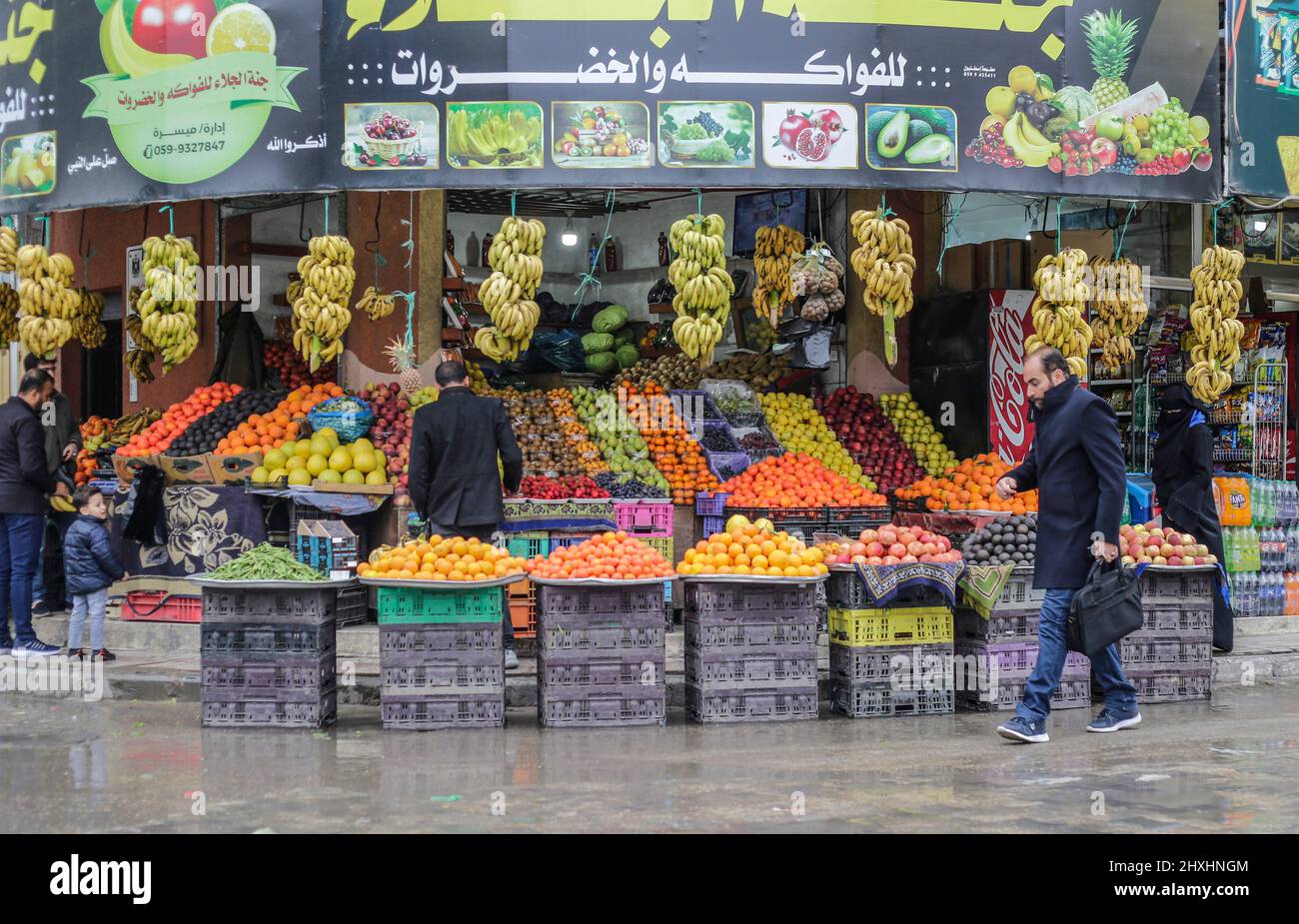 A Palestinian man walks by a grocery store in Gaza City. (Photo by